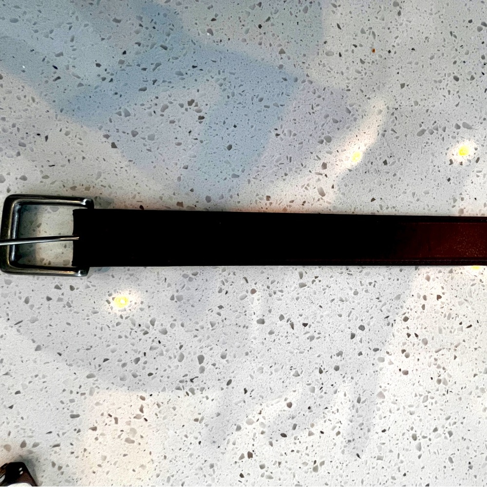 Genuine leather.Buckle snaps. Size 42.  Worn twice. Dark brown w/red undertone.